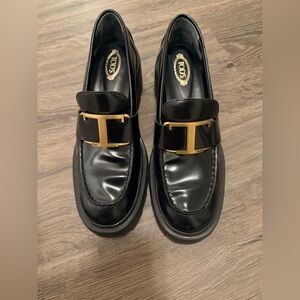 Tod's Shiny Black Loafers with Gold Accent